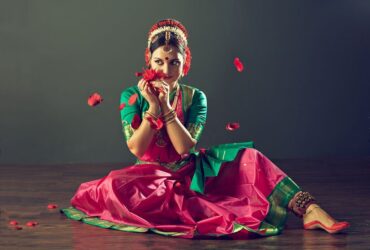 Girl, dressed in traditional national costume, dancing classical indian dance Kuchipudi. Emotional gestures of indian dance kuchipudi.